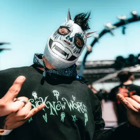 A festival-goer in a luchador mask wearing a Sick New World shirt